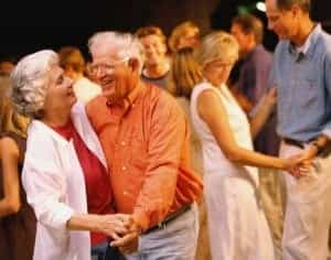 Man and woman dancing among a group of people